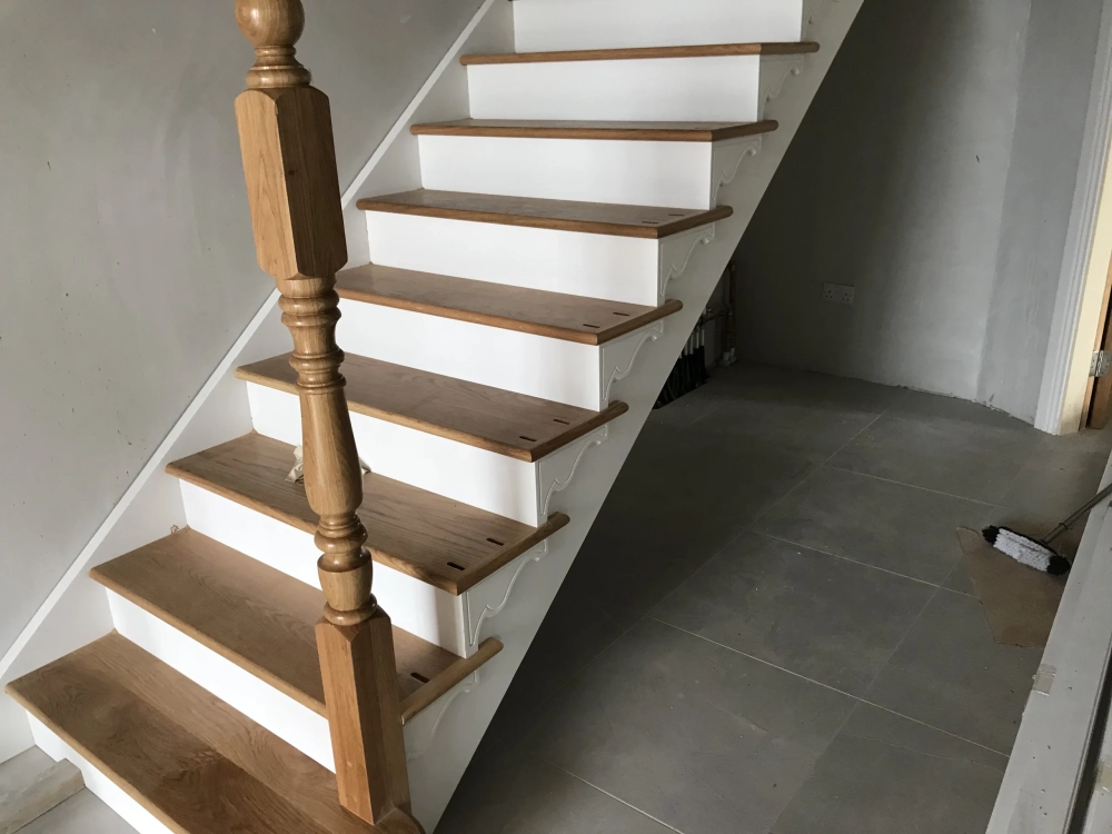 Wooden stairs with white skirting